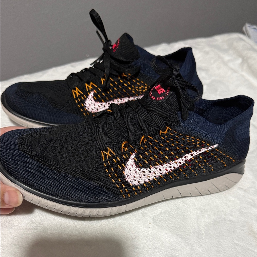 Nike Black Knit Athletic Shoes with White Swoosh and Orange Accents
